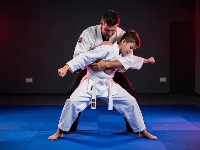 A child demonstrating the bear-hug escape