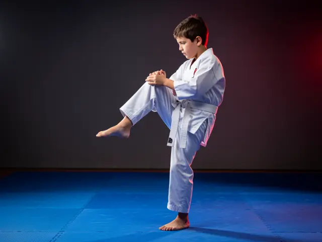A child demonstrating the knee strike