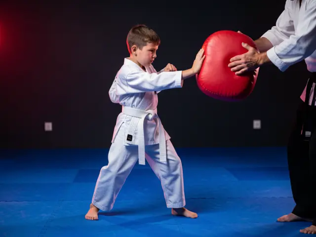 A child demonstrating the palm-heel strike